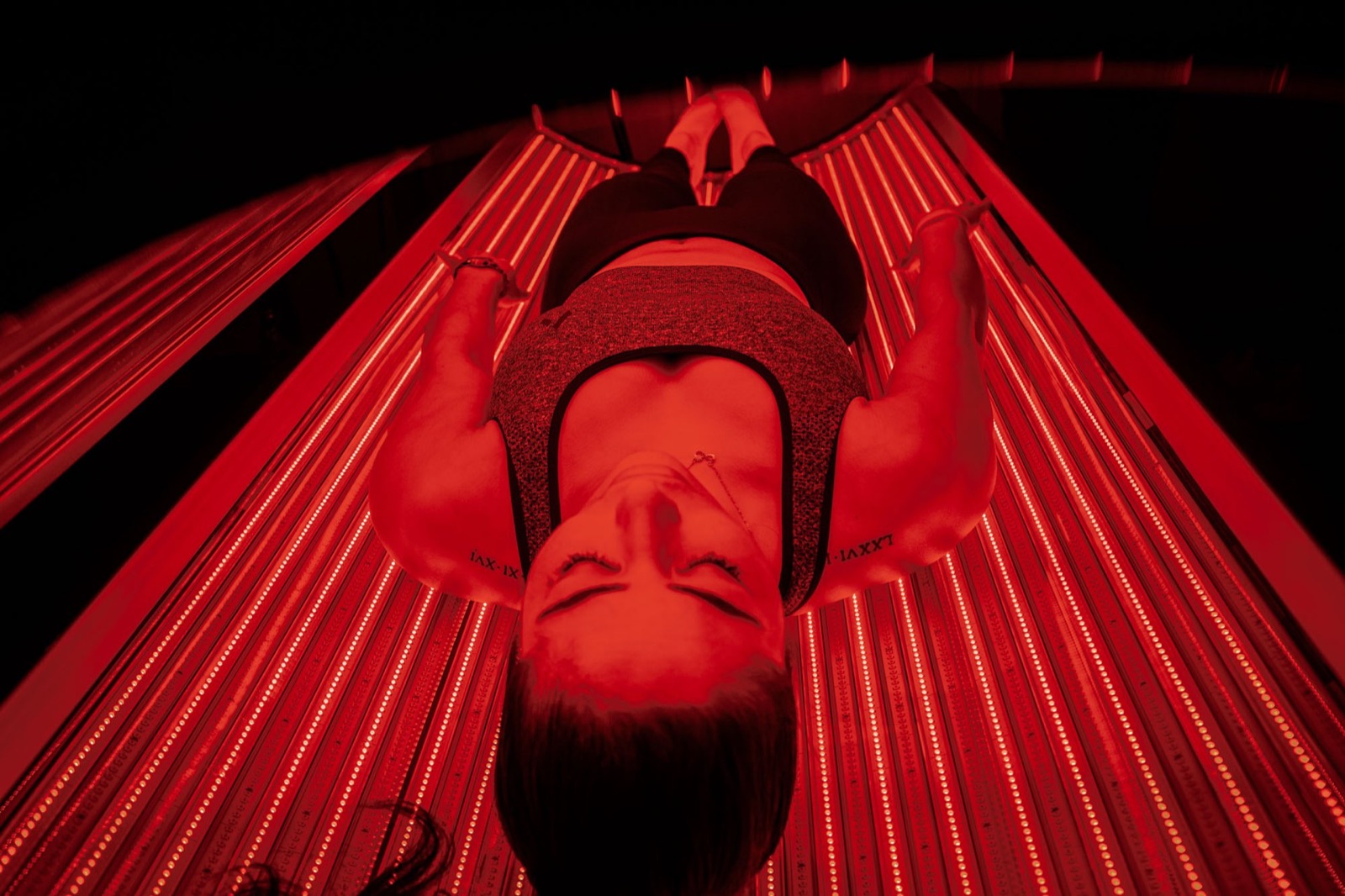 Client in a red light therapy bed